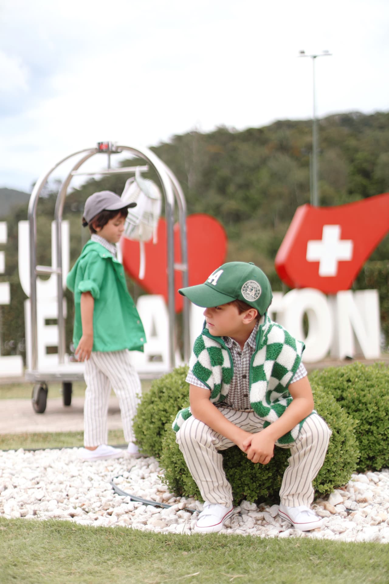 Crianças brincando no letreiro Eu amo Le Canton
